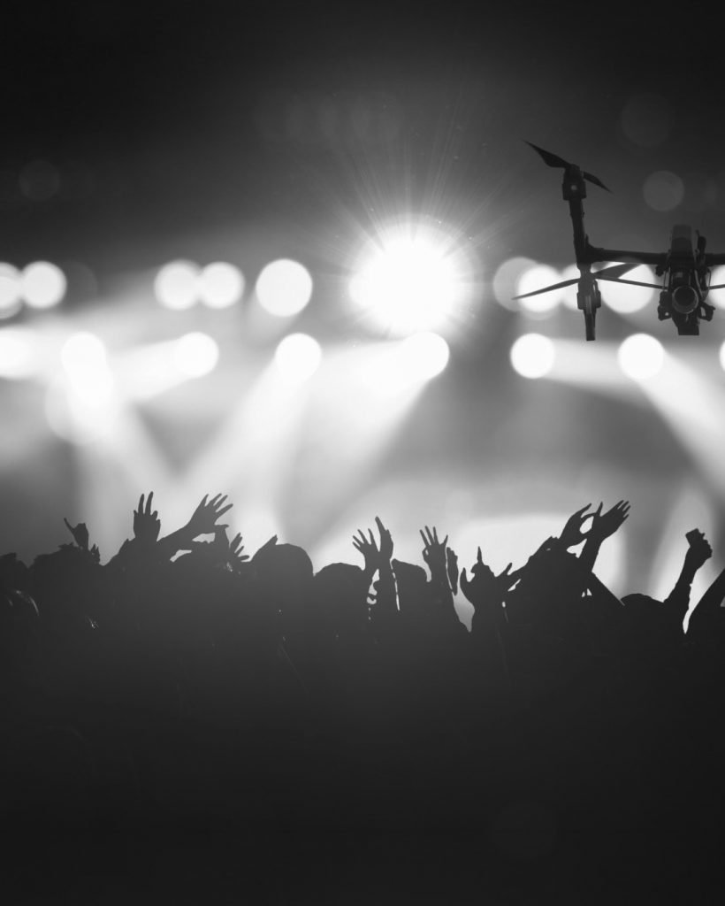 closeup-silhouette-of-drone-flying-for-taking-video-of-concert-crowd